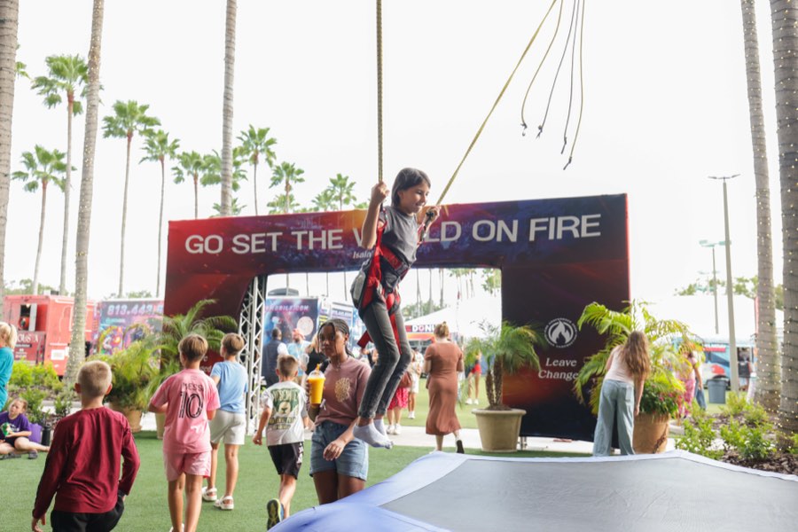A child riding the mobile zip line