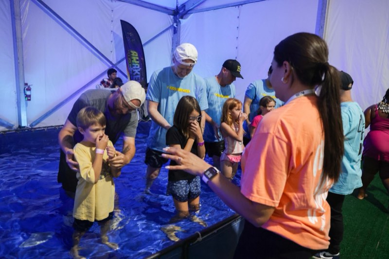 A child being baptised in water