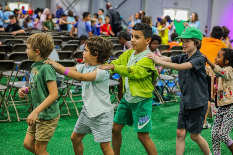 Children playing games before service