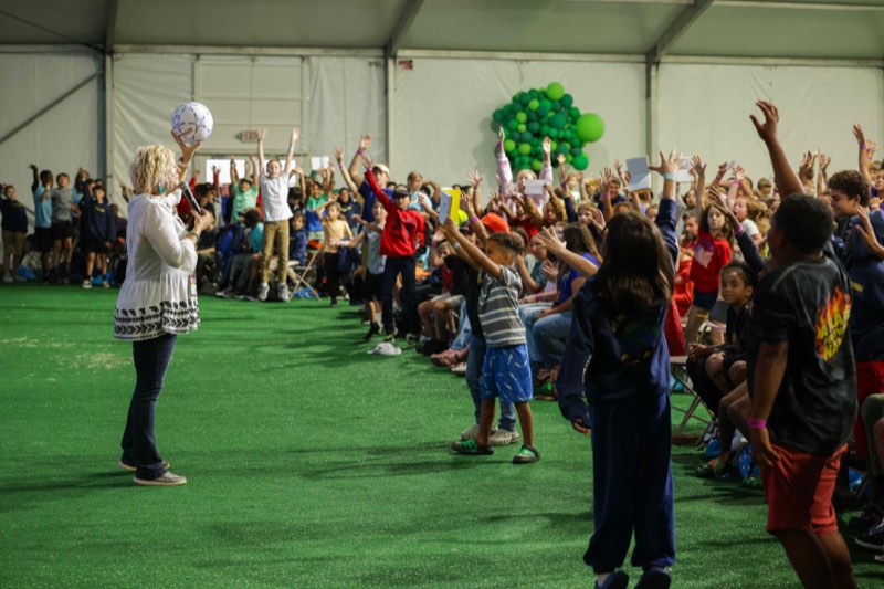 Children cheering during a prize giveaway