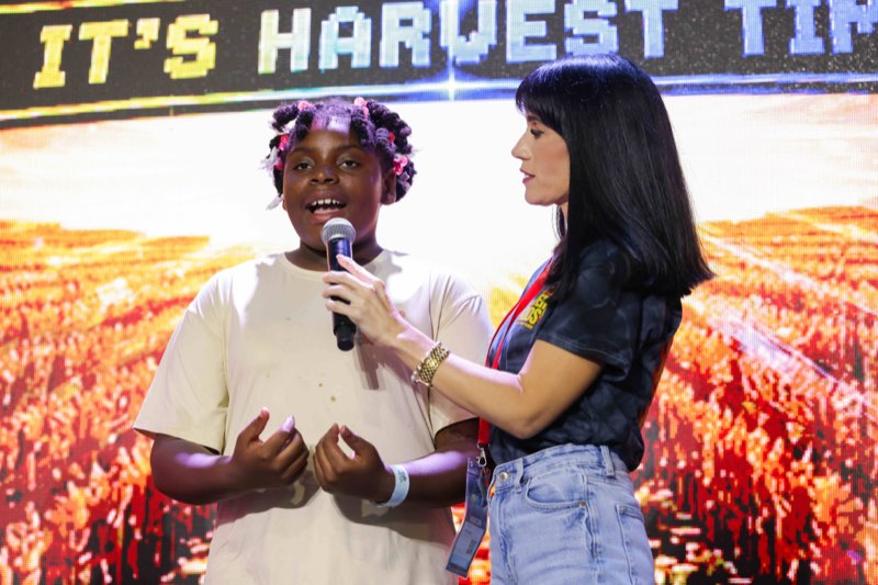A child sharing a testimony on stage