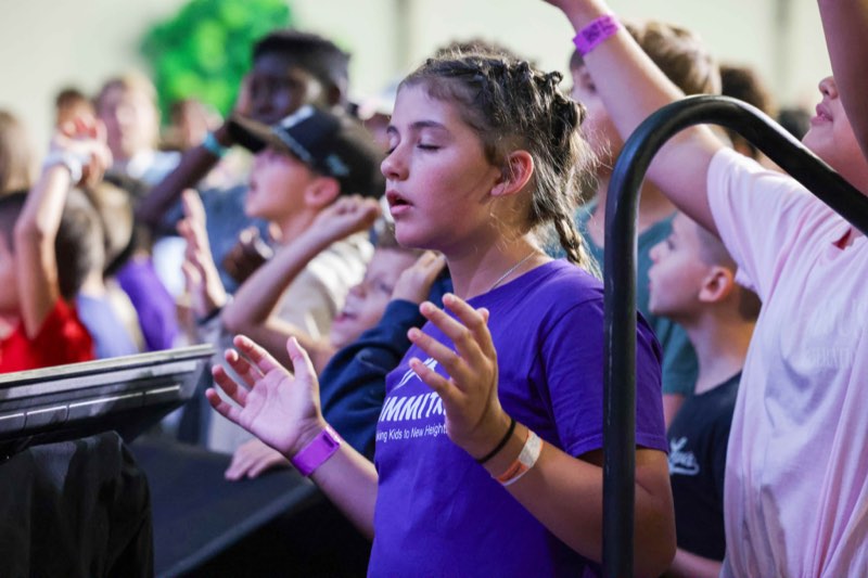 Children worshipping in the Kids Week tent