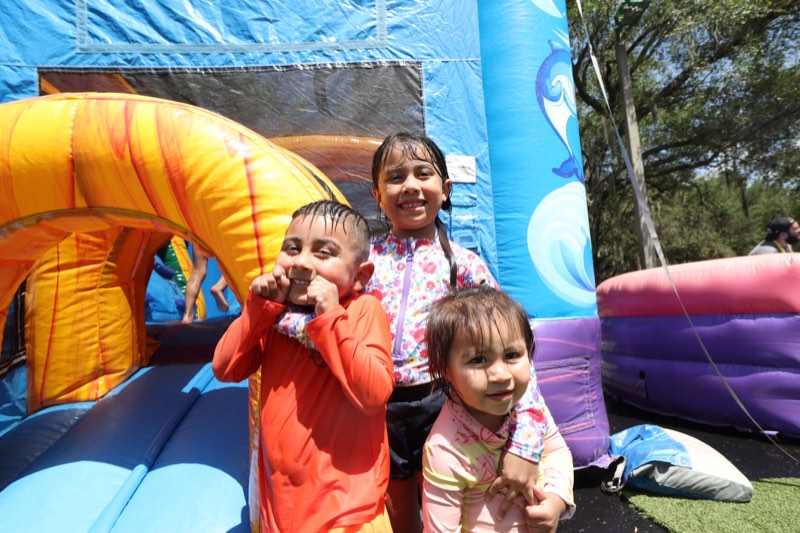 A child coming down an inflatable water slide